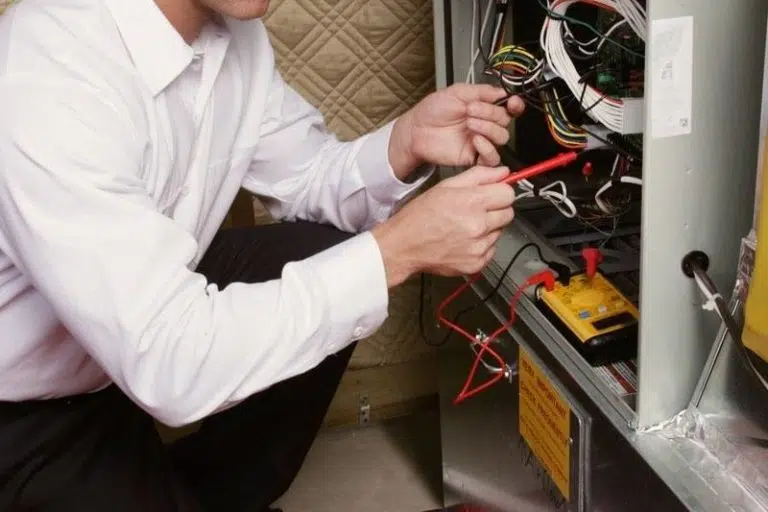 Technician fixing furnace